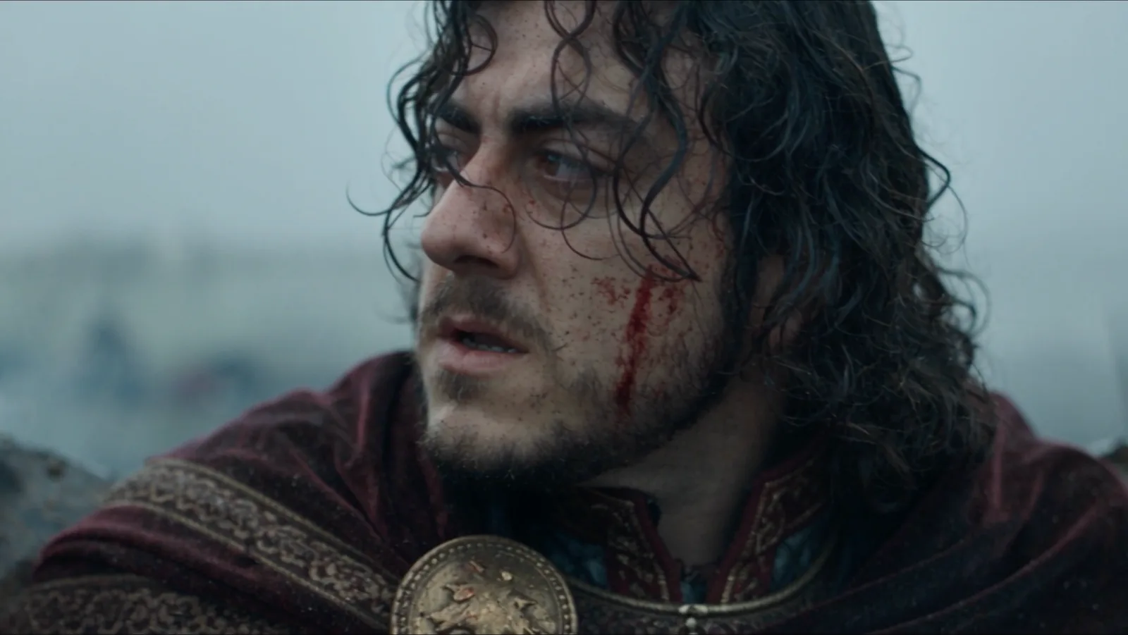 Close-up of Vakhtang with wet hair and blood flecks on his face.