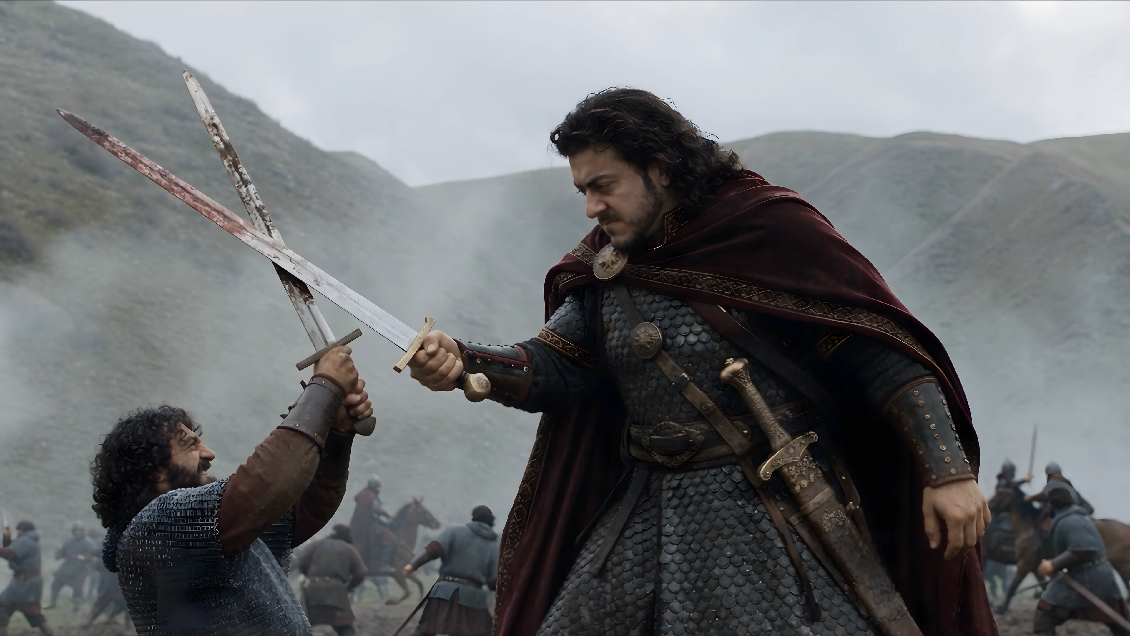 Vakhtang crosses swords with another fighter in a misty mountain landscape.